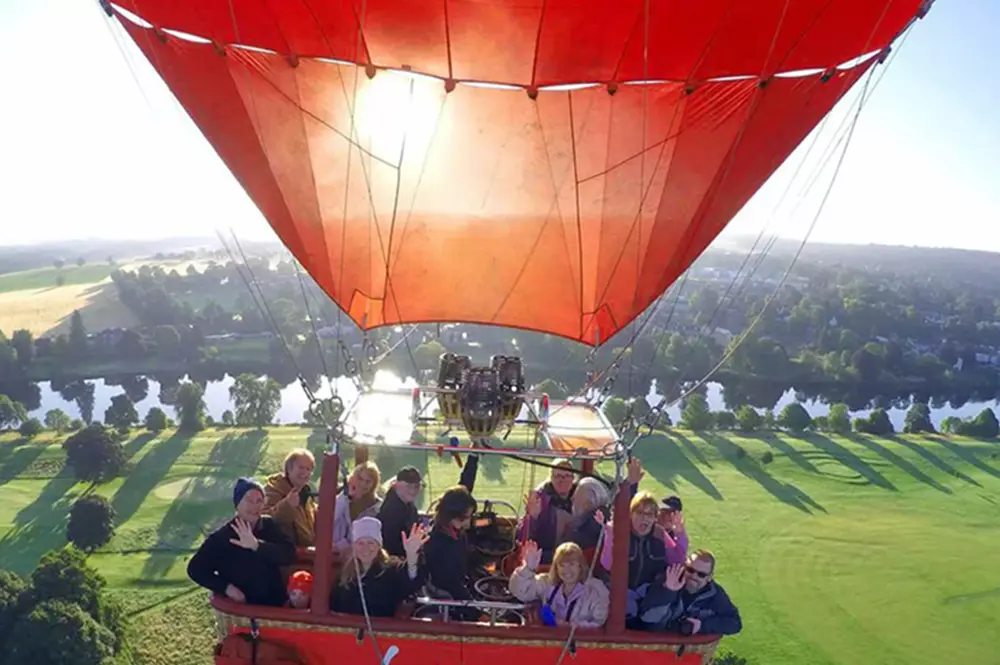 Passengers enjoying a hot air balloon flight over Fernhurst